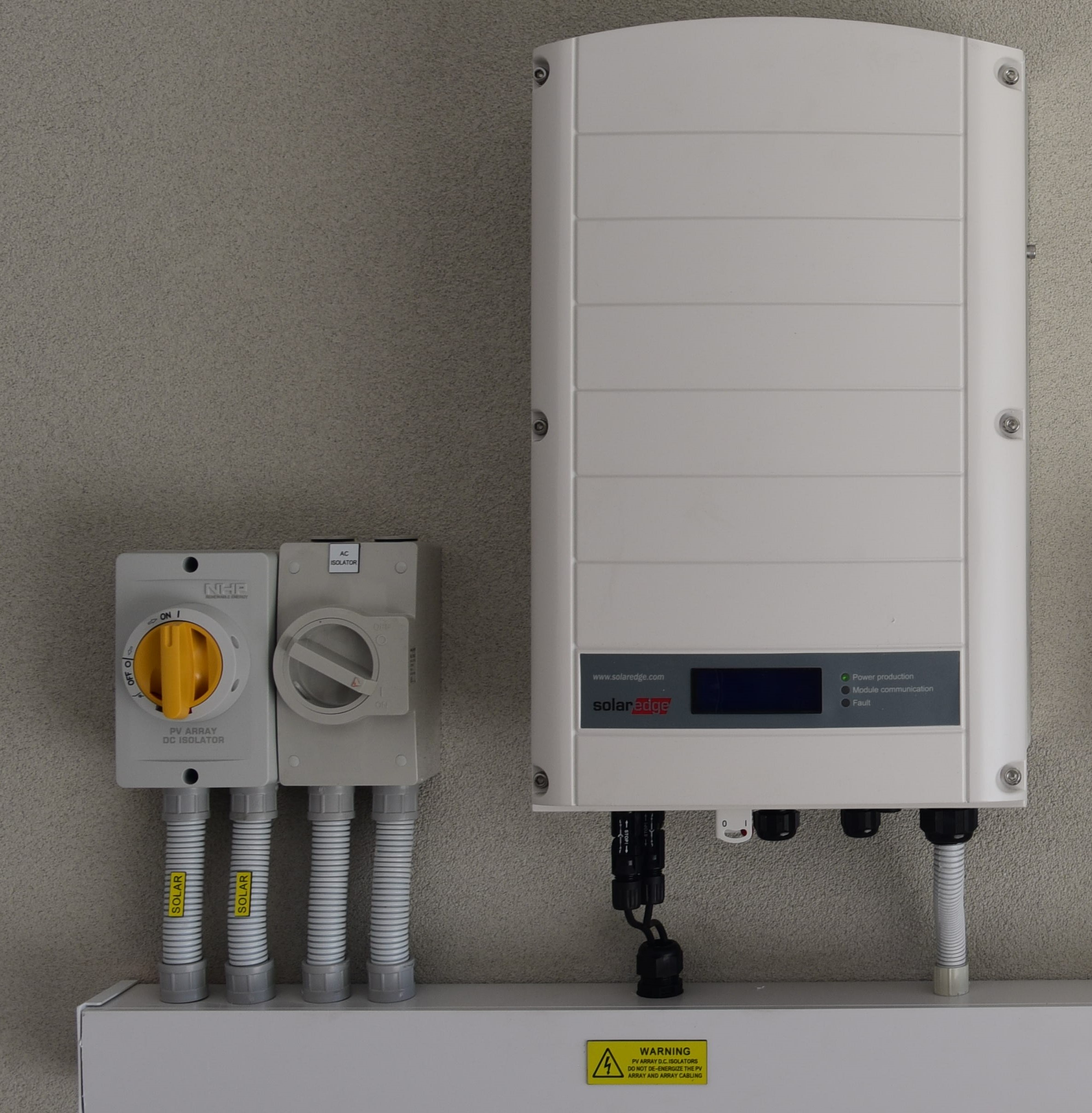 Converts solar energy into usable AC power for homes and businesses.